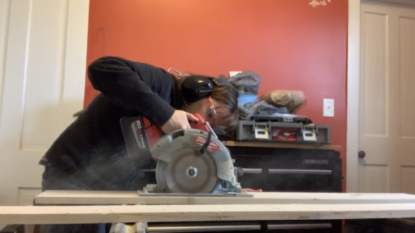 Lora Frost using a circular saw during hands-on construction work